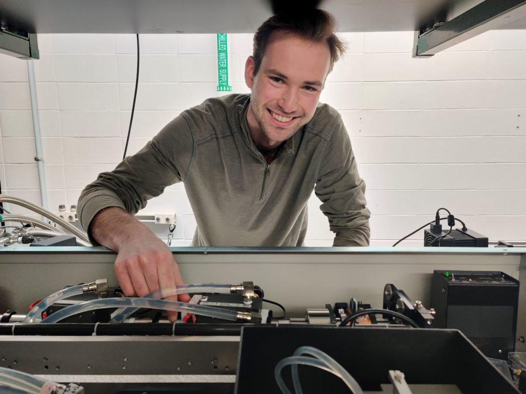 researcher adjusting laser in lab